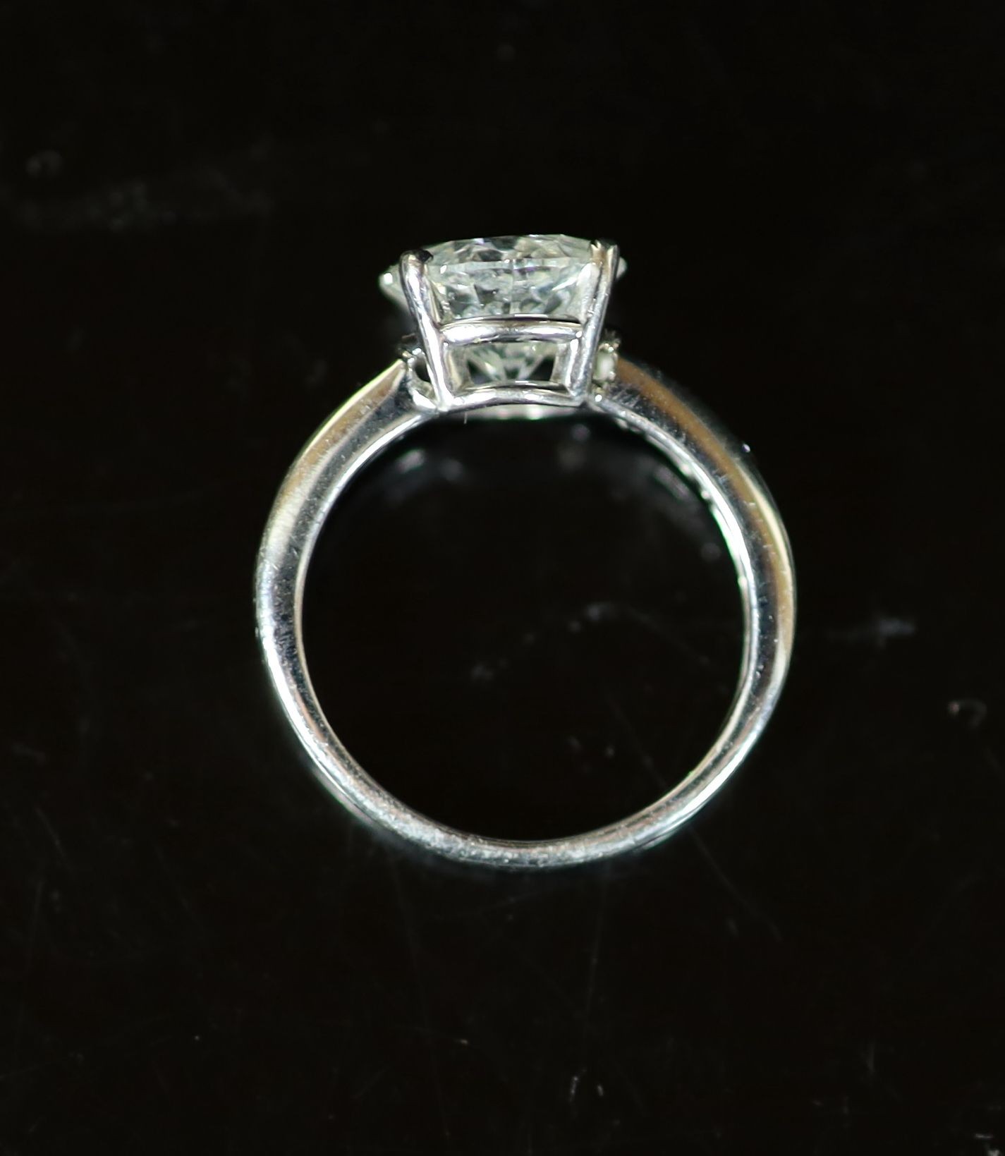 A modern white gold and single stone diamond ring, with eight stone diamond set shoulders